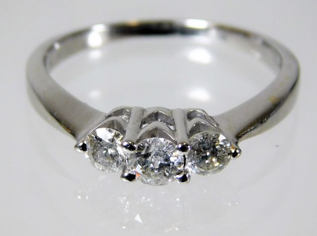 A 14ct gold ring set with three diamonds of approx