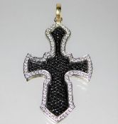 A heavy gauge 18ct gold cross set with black & whi