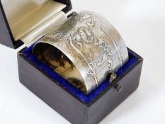 A large silver napkin ring with thistle decor & ca