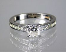 An 18ct gold ring set with approx. 0.65ct centre s