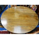 A large oak pedestal dining table 54in diameter x