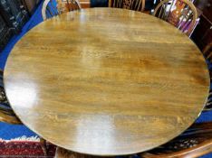 A large oak pedestal dining table 54in diameter x