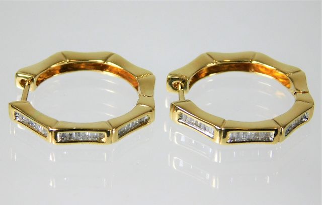 A pair of fine quality 18ct gold earrings set with