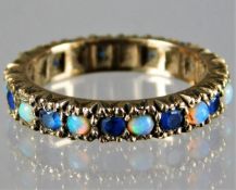 A yellow metal antique eternity ring set with sapp