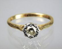 A yellow metal ring set with 0.2ct illusion set di