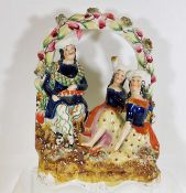 A 19thC. Staffordshire figure group, loss of feath