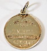 A silver Clayworks medal awarded for long service