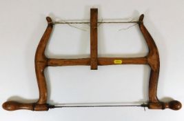 A late 19thC. walnut bow saw