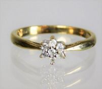 A 9ct gold ring set with diamonds in floral design