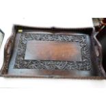 A carved wood tray with grape & vine decor