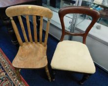 A c.1900 elm farmhouse chair twinned with an uphol