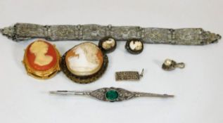 A white metal brooch set with green & white stones