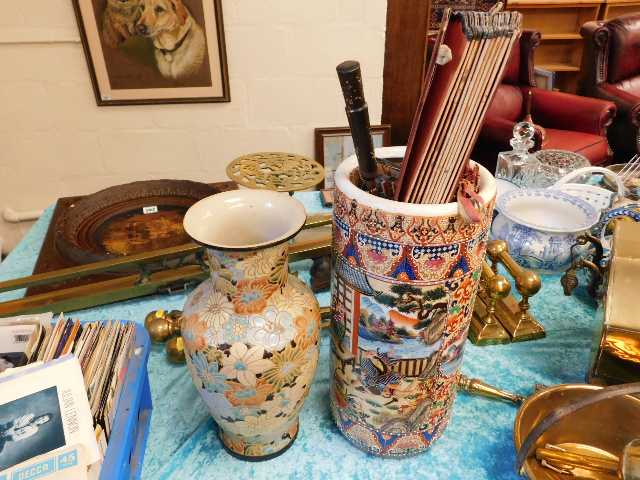 A ceramic stick stand with oriental design, a deco