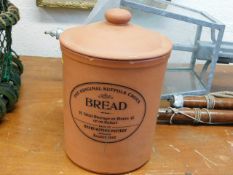 A terracotta bread crock