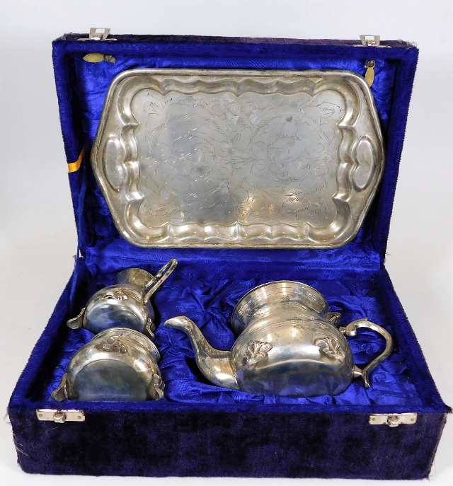 A boxed silver plated bachelor tea set with tray