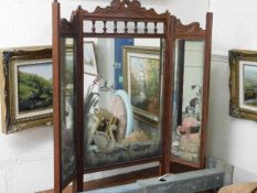 A carved mahogany painted mirror triptych