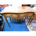 A serpentine mahogany side table with drawers