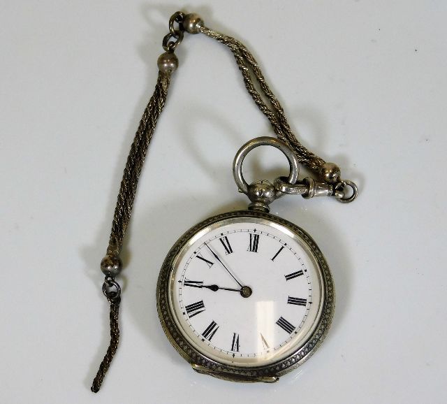 A silver pocket watch, not running