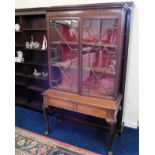 A mahogany glazed display cabinet & later a matched ball & claw foot stand, as found with faults