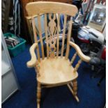 A 20thC. beech rocking chair