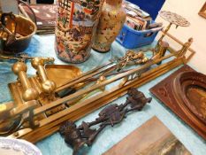 A brass extending art nouveau fender, a companion