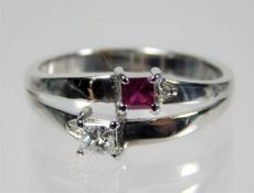 A 14ct white gold ring set with ruby & diamond siz