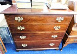 A mahogany chest of drawers with brass fittings