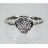 An 18ct white gold ring with heart shaped diamond setting of 0.33ct size N