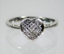 An 18ct white gold ring with heart shaped diamond setting of 0.33ct size N