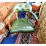 A green leather office chair