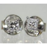 A pair of platinum earrings set with fine princess