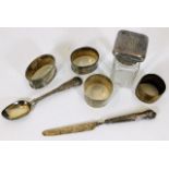 Four silver napkin rings, a silver spoon & other i