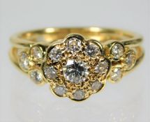 An 18ct gold daisy style ring set with approx. 1ct