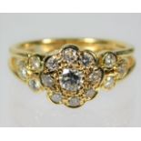 An 18ct gold daisy style ring set with approx. 1ct