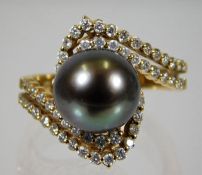 An 18ct gold ring set with diamond & 10mm tahitian