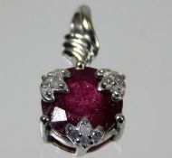 A 9ct white gold pendant set with ruby & diamond 1