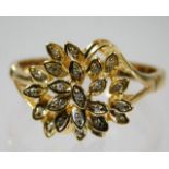 An 18ct gold diamond cocktail ring of organic form with diamonds set within leaves size S/T 4.2g