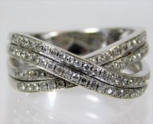 A 14ct white gold crossover ring set with diamonds