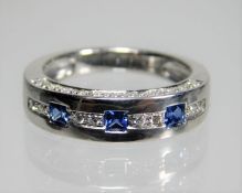 An 18ct white gold ring set with approx. 0.3ct diamond & three square cut very fine grade sapphires