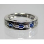 An 18ct white gold ring set with approx. 0.3ct diamond & three square cut very fine grade sapphires