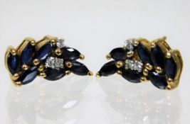 A pair of 9ct gold earrings set with sapphire & di