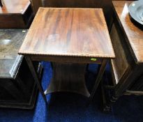 An Edwardian style two tiered mahogany table