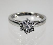 An 18ct white gold diamond ring of floral setting