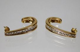A pair of 9ct gold earrings set with 1.2ct diamond