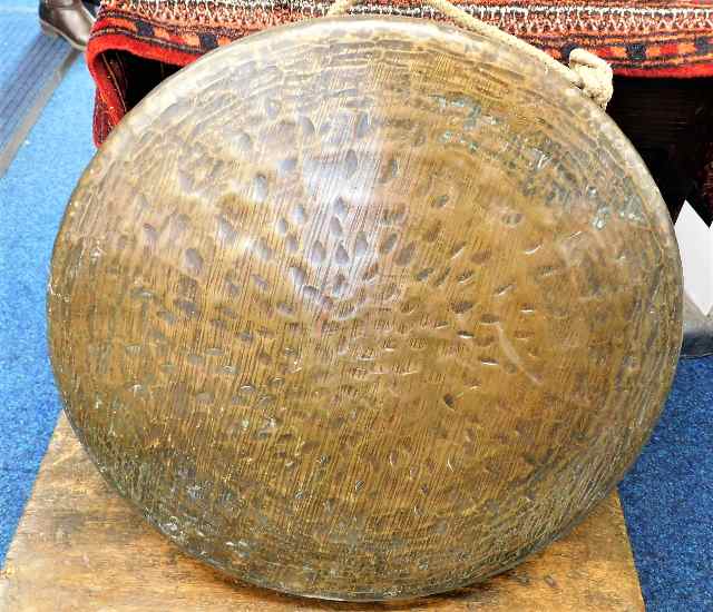 A 19thC. bronze dinner gong with hammered decor 19