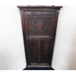 A c.1900 carved oak corner cabinet