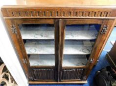 An oak glazed bookcase