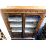 An oak glazed bookcase