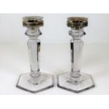 A pair of silver topped glass candle holders