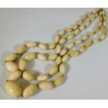 A Victorian double string ivory necklace 77.4g